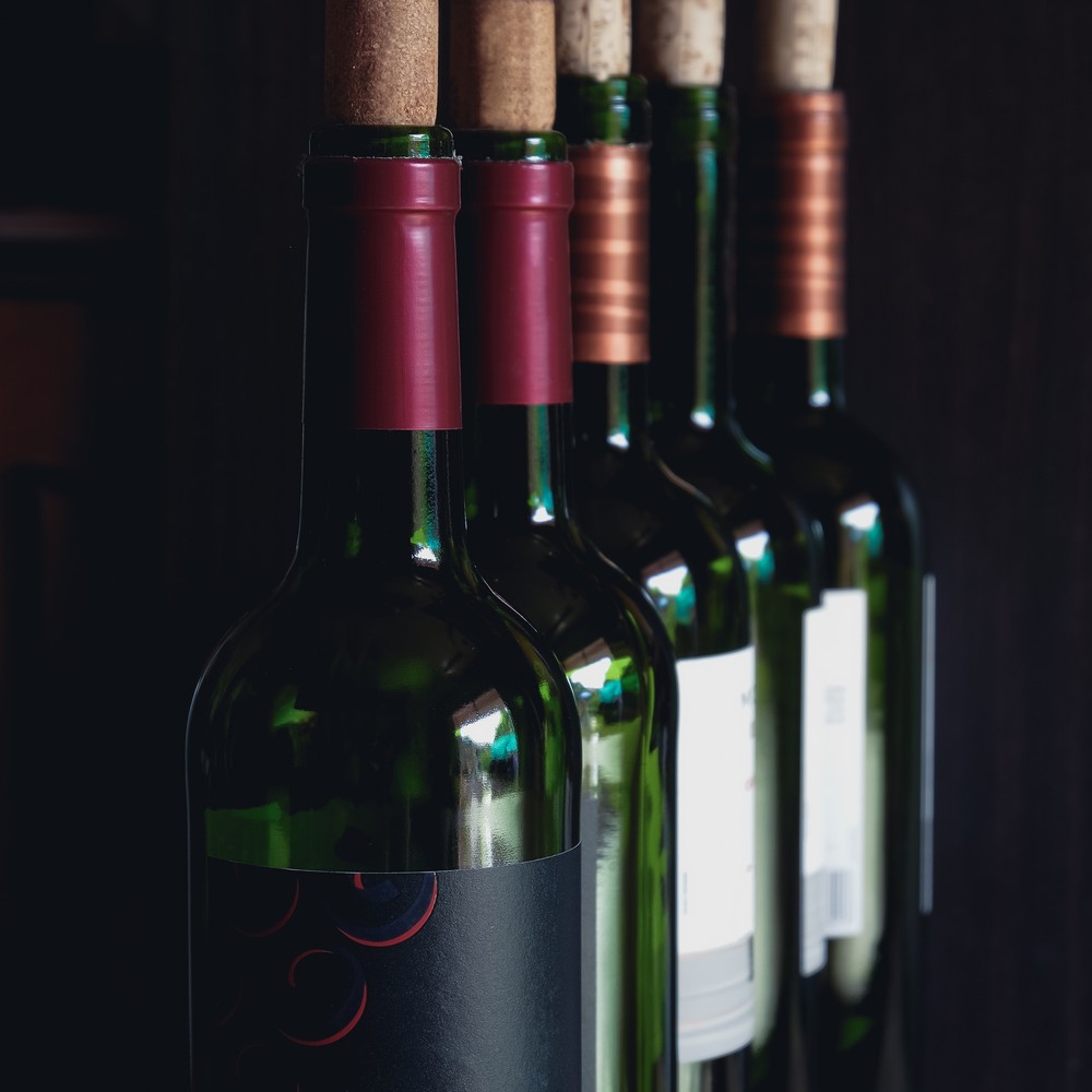 Close up of opened wine bottles ready to serve.
